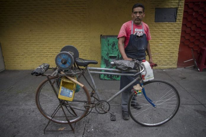 Knife sharpener on his bike
