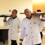 Waiters carrying trays in a hotel