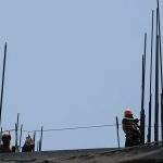 Construction workers setting up the metal support rods to a building, an image to illustrate foreign investment in Mexico