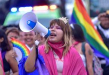 A girl holds a speaker during a pride event in Acapulco, Mexico