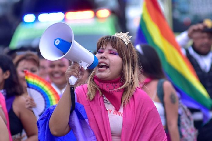 Marcha Lésbica Acapulco-1 A girl holds a speaker during a pride event in Acapulco, Mexico