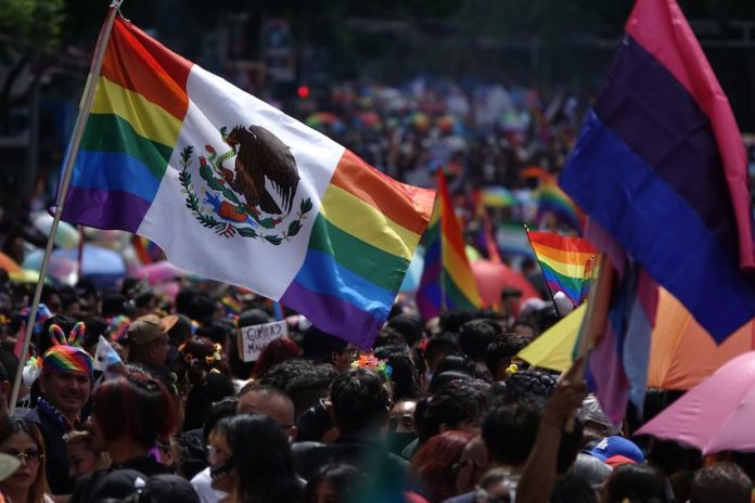 46Āŗ Marcha Orgullo CDMX-11 A flag flies at the 2024 Mexico City pride parade