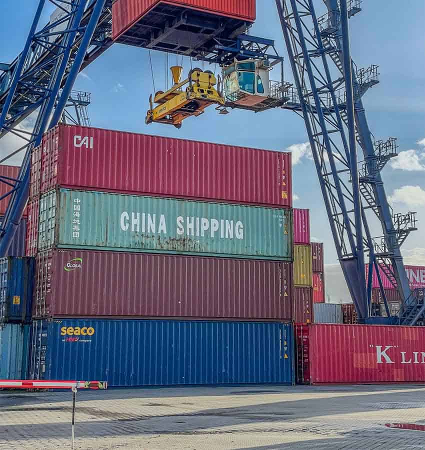 Shipping containers being lifted by a crane