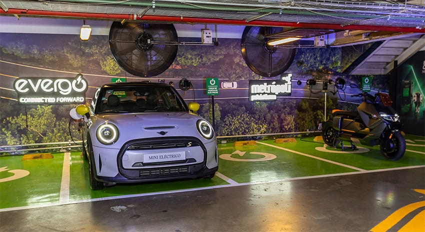 A car in a parking garage at an electric charger station featuring the Evergo logo