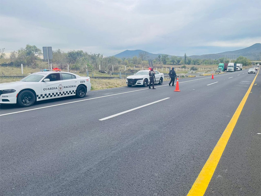 National Guard patrol cars parked along a highway