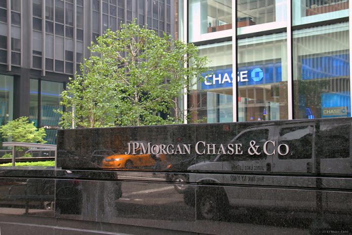 jpmorgan-chase-850 A stone sign reading JPMorgan & Chase Co. in front of a tree and tall buildings