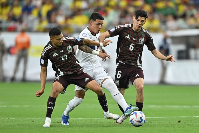 mexico-ecuador copa america Two Mexican soccer players in red uniforms go after an Ecuadorian player in white with the ball, before Mexico was eliminated from the Copa América.