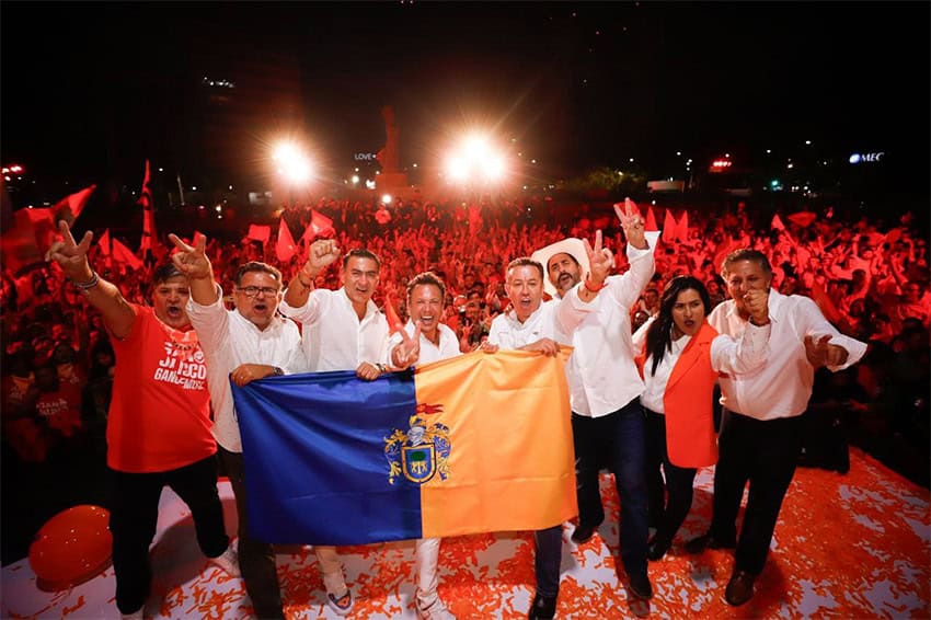 MC gubernatorial candidate Pablo Lemus waves a Jalisco flag in front of a crowd of supporters, after early results showed him winning the election.