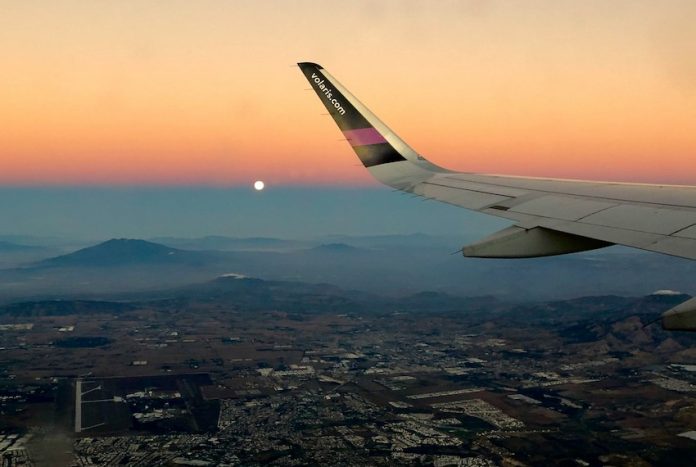 tess-broker-pAi-KJoYReA-unsplash A Volaris plane flying over Mexico